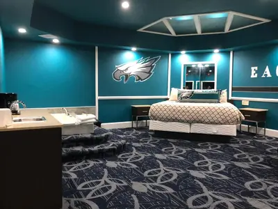 a bedroom with a bed and a blue wall at Inn of the Dove Cherry Hill - Philadelphia in Cherry Hill
