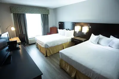 a hotel room with two beds and a window at Country Inn & Suites by Radisson, Harrisburg West Mechanicsburg in Mechanicsburg