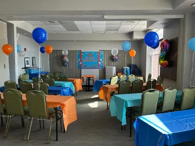 a room with blue and orange tables and balloons at Country Inn & Suites by Radisson, Harrisburg West Mechanicsburg in Mechanicsburg