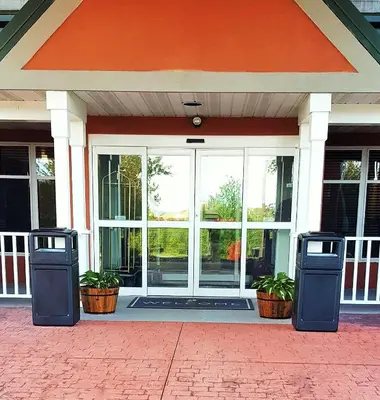 two trash cans sitting in front of a building at Country Inn & Suites by Radisson, Harrisburg West Mechanicsburg in Mechanicsburg