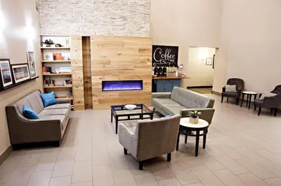 a lobby with couches and chairs and a fireplace at Country Inn & Suites by Radisson, Harrisburg West Mechanicsburg in Mechanicsburg