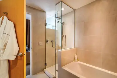a bathroom with a shower and a tub and a sink at Concorde Hotel New York in New York