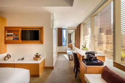 a hotel room with a bed and a desk at Concorde Hotel New York in New York