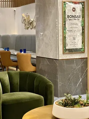 a green chair and a table in a restaurant at Concorde Hotel New York in New York