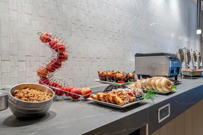 a buffet with various food items on a counter at Sheraton Suites Wilmington Downtown in Wilmington