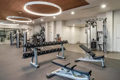 a gym with several treadmills and cardio machines at Sheraton Suites Wilmington Downtown in Wilmington
