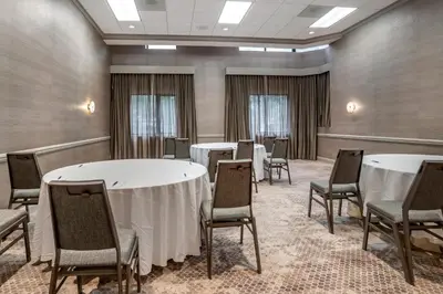 a conference room with tables and chairs in it at Sheraton Suites Wilmington Downtown in Wilmington