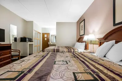 a hotel room with two beds and a television at Quality Inn & Suites Binghamton Vestal in Binghamton