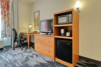 a hotel room with a microwave and a television at Fairfield Inn & Suites by Marriott Harrisburg West/New Cumberland in New Cumberland