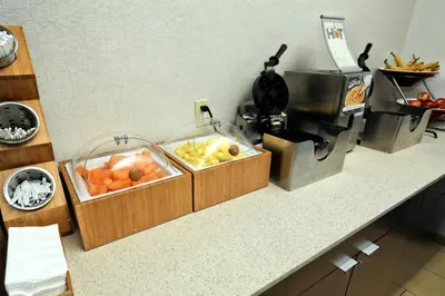 a kitchen counter with two bins of fruit on it at Fairfield Inn & Suites by Marriott Harrisburg West/New Cumberland in New Cumberland