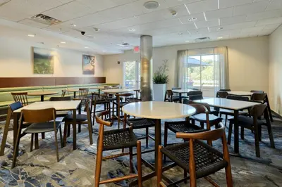 a dining room with tables and chairs at Fairfield Inn & Suites by Marriott Harrisburg West/New Cumberland in New Cumberland