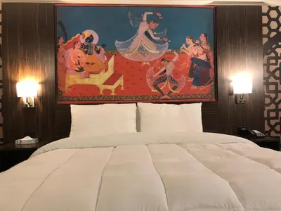 a large painting above a bed in a hotel room at The Lincoln Hotel Philadelphia in Trevose