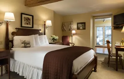 a hotel room with a large bed and a desk at Glasbern in Fogelsville