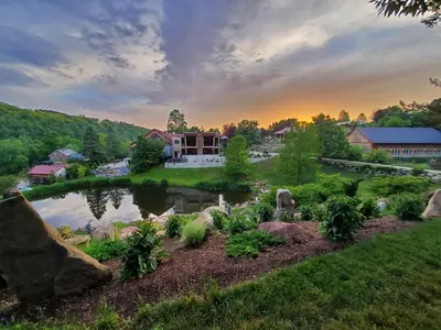 a house with a pond in a yard at Glasbern in Fogelsville