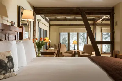 a bedroom with a large bed with white pillows at Glasbern in Fogelsville