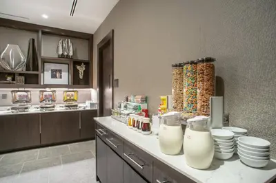 a kitchen with a counter with plates and milk at Residence Inn by Marriott Weehawken in Weehawken