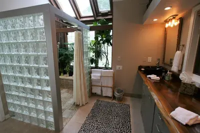 a bathroom with a sink and a shower with a window at Alpenhof Bed & Breakfast in Media