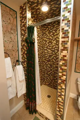 a bathroom with a shower with a glass door at Alpenhof Bed & Breakfast in Media