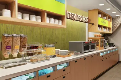 a kitchen with a counter with food on it at Home2 Suites By Hilton Lancaster in Lancaster