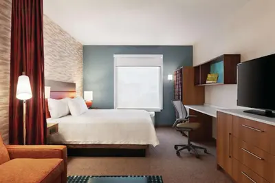 a hotel room with a bed and a desk at Home2 Suites By Hilton Lancaster in Lancaster