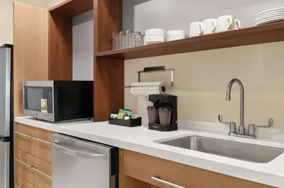 a kitchen with a sink and a microwave at Home2 Suites By Hilton Lancaster in Lancaster