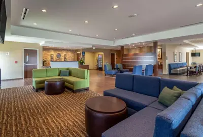 a hotel lobby with couches and a waiting room at Comfort Inn & Suites - Harrisburg Airport - Hershey South in Middletown