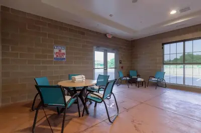 a waiting room with chairs and a table and a sign at Comfort Inn & Suites - Harrisburg Airport - Hershey South in Middletown