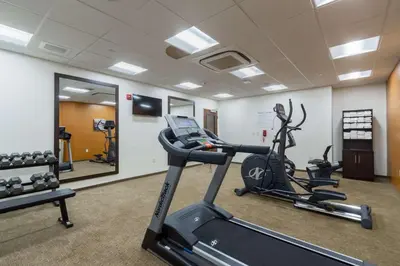 a gym with a treadmill and a elliptical machine at Comfort Inn & Suites - Harrisburg Airport - Hershey South in Middletown