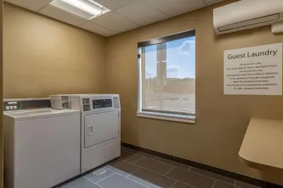 a laundry room with a washer and a window at Comfort Inn & Suites - Harrisburg Airport - Hershey South in Middletown