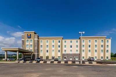 a large building with a parking lot in front of it at Comfort Inn & Suites - Harrisburg Airport - Hershey South in Middletown