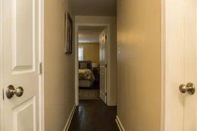 a hallway with a door leading to a bedroom at Red brick house in Chalfont