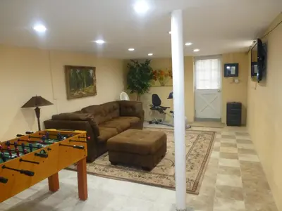 a living room with a couch and a table at Red brick house in Chalfont