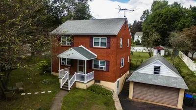 an aerial view of a brick house with a garage at Red brick house in Chalfont