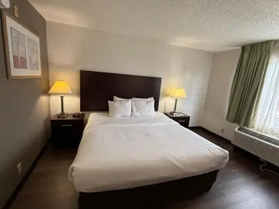 a hotel room with a large bed and two lamps at Quality Inn Newark - Wilmington in Newark
