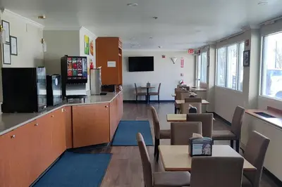 a dining room with tables and chairs and a bar at Quality Inn Newark - Wilmington in Newark