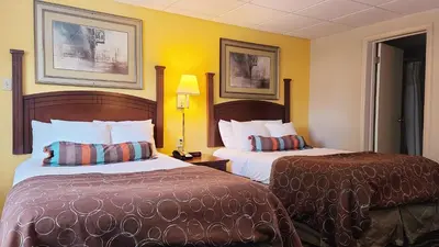 two beds in a hotel room with yellow walls at Hampton Inn (not a Hilton Affiliate) Camp Hill - Harrisburg SW in Harrisburg