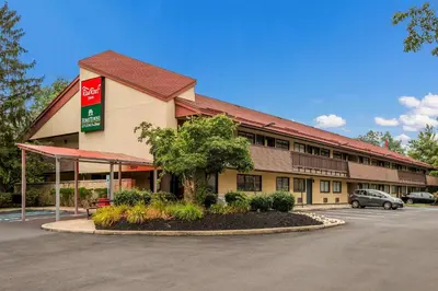 a front view of a hotel with a parking lot at Red Roof Inn Princeton - Ewing in Lawrenceville