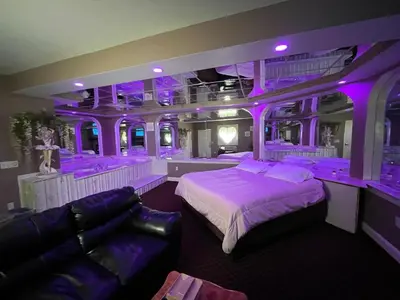 a bus room with a bed and a couch at Gallery Holiday Motel in South Amboy