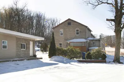 a house in the snow in front of a house at OYO Hotel Wilkes-Barre East in Wilkes-Barre