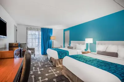 a hotel room with two beds and a blue wall at Howard Johnson by Wyndham Hershey in Hershey