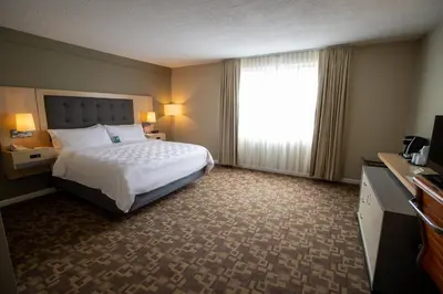 a hotel room with a bed and a window at Holiday Inn Scranton East - Dunmore by IHG in Dunmore