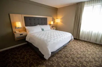 a hotel room with a large bed and a window at Holiday Inn Scranton East - Dunmore by IHG in Dunmore