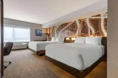 a hotel room with two beds and a window at Cambria Hotel West Orange in West Orange
