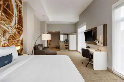 a hotel room with a bed and a desk at Cambria Hotel West Orange in West Orange