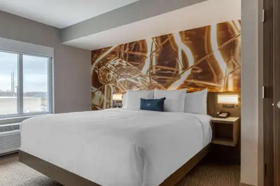 a bedroom with a large white bed and a window at Cambria Hotel West Orange in West Orange