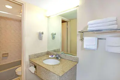 a bathroom with a sink and a toilet and a mirror at Knights Inn South Hackensasck in South Hackensack