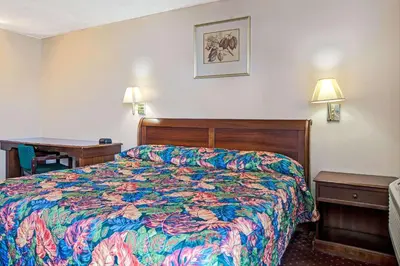 a hotel room with a bed and a desk at Knights Inn South Hackensasck in South Hackensack