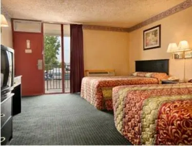 a hotel room with two beds and a television at Knights Inn South Hackensasck in South Hackensack