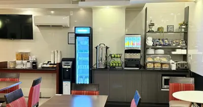 a restaurant with a counter and tables and chairs at Madison LES Hotel in New York