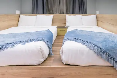 two beds sitting next to each other in a room at Madison LES Hotel in New York